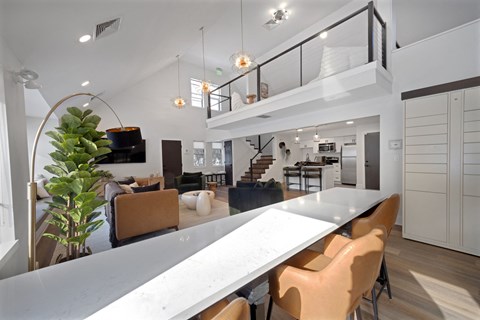 A modern dining area with a long table and chairs.