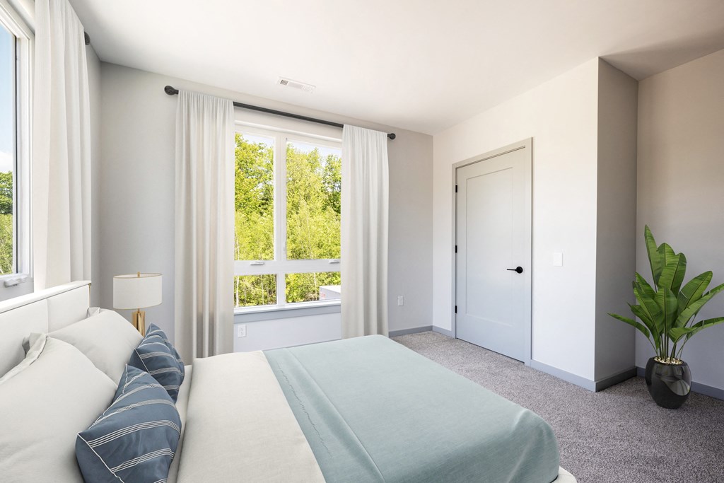 a bedroom with a large bed and a large window