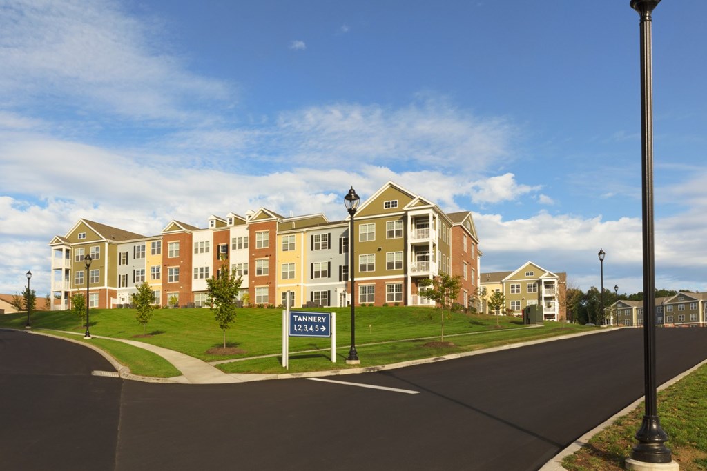 A street view of apartment buildings with a sign that says Tannen.