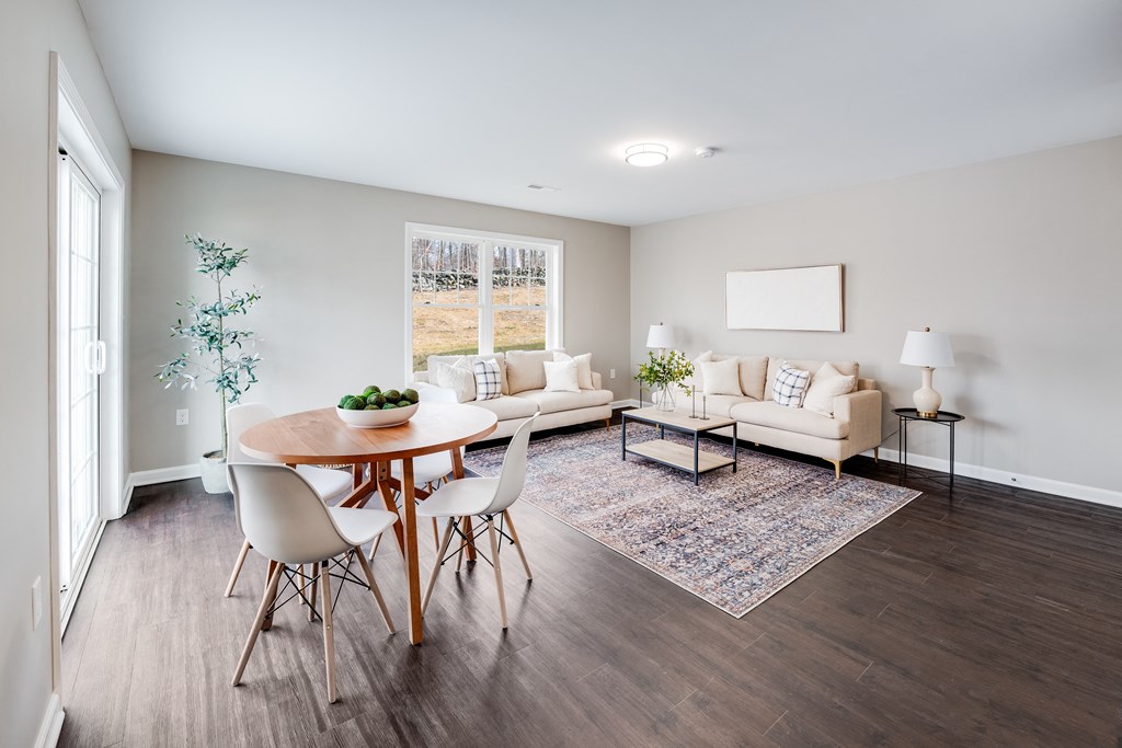 a living room with a table and chairs and a couch at Pleasant View Estates, Griswold, 06351