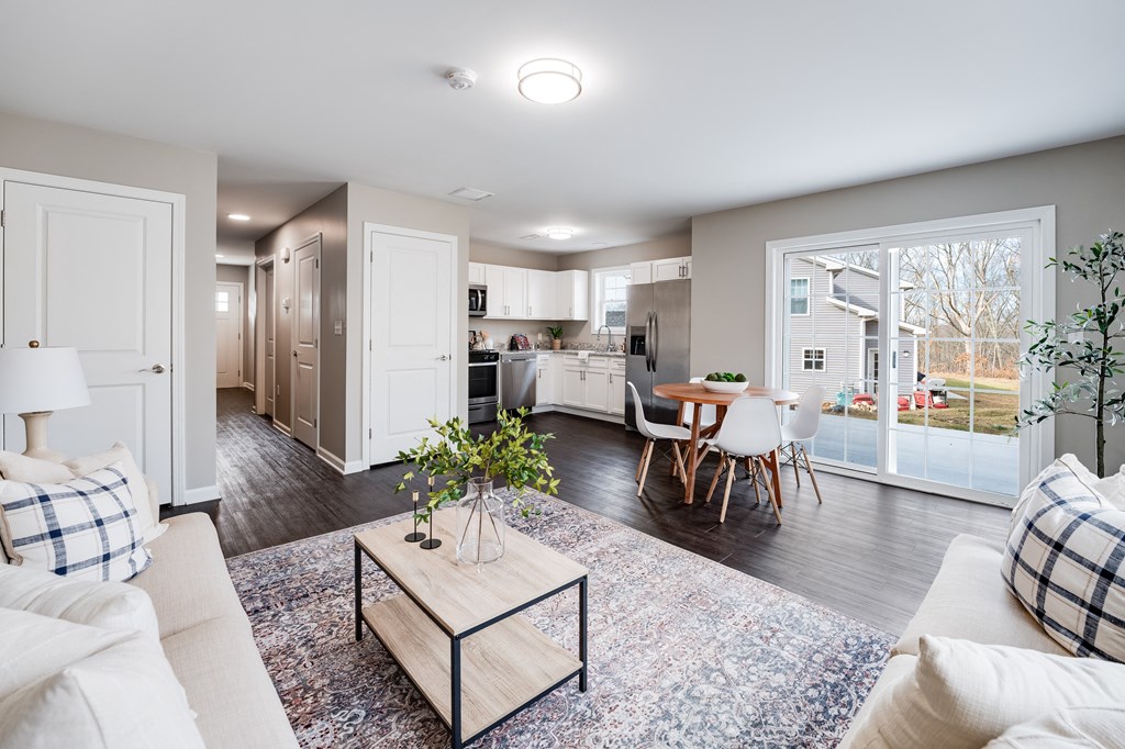 an open living room and kitchen with a sliding glass door at Pleasant View Estates, Connecticut