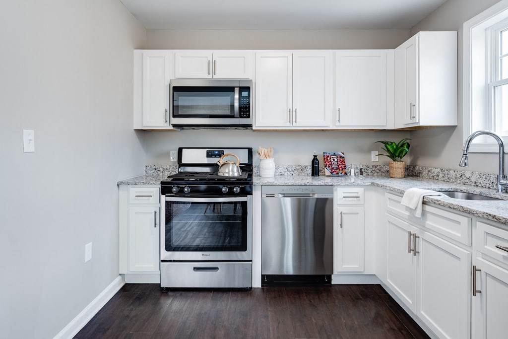 a kitchen with stainless steel appliances and white cabinets at Pleasant View Estates, Griswold, Connecticut