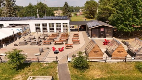 Outdoor beer garden with solar panels at Pointe28 Apartments, Brunswick, ME 4011