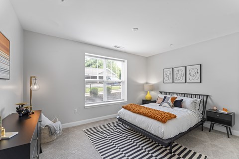 A bedroom with a large bed and a desk.