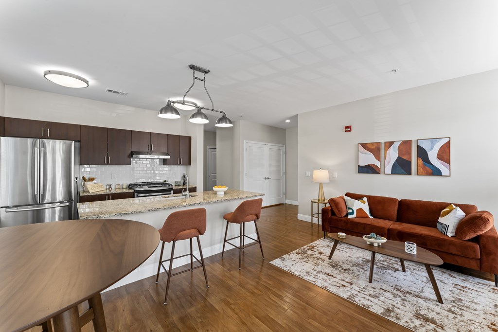 A modern kitchen with a dining table and chairs.