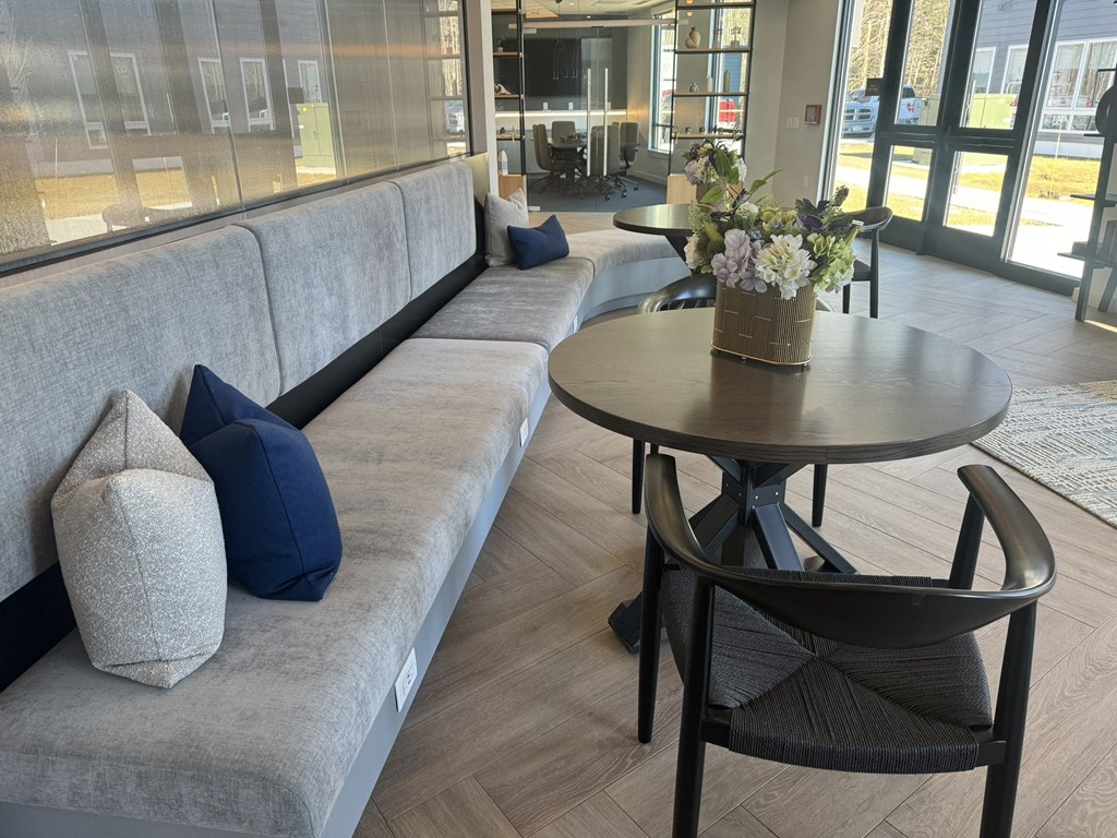a seating area with couches and a table with flowers