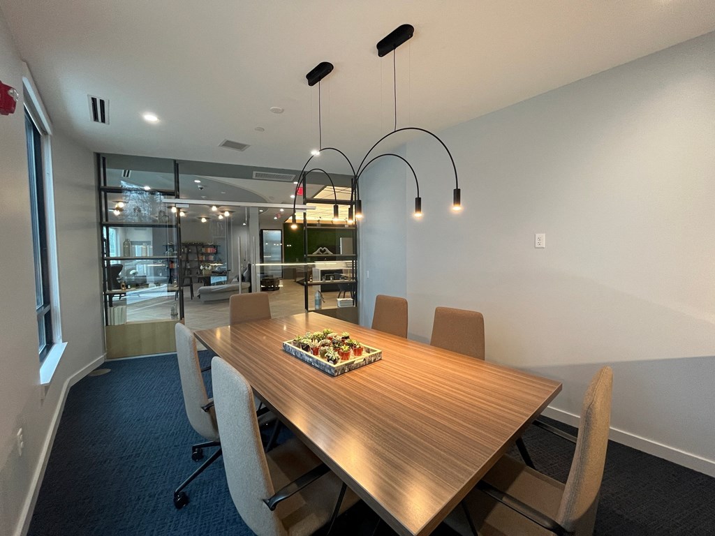 a conference room with a wooden table and chairs