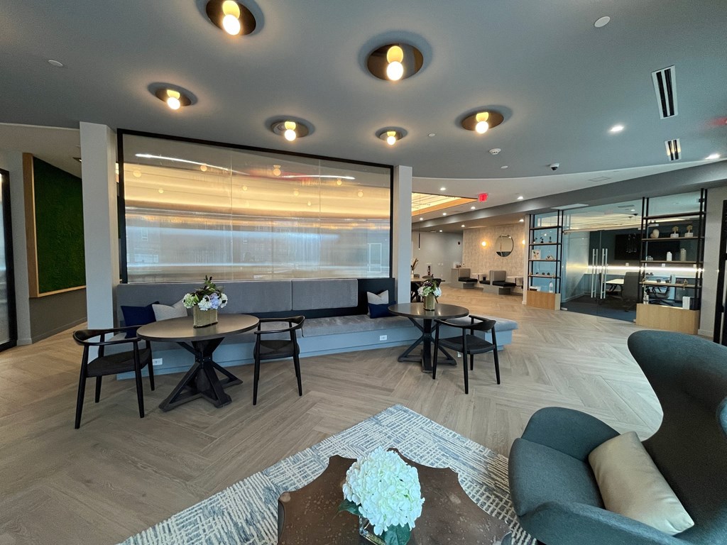 a large lobby with tables and chairs