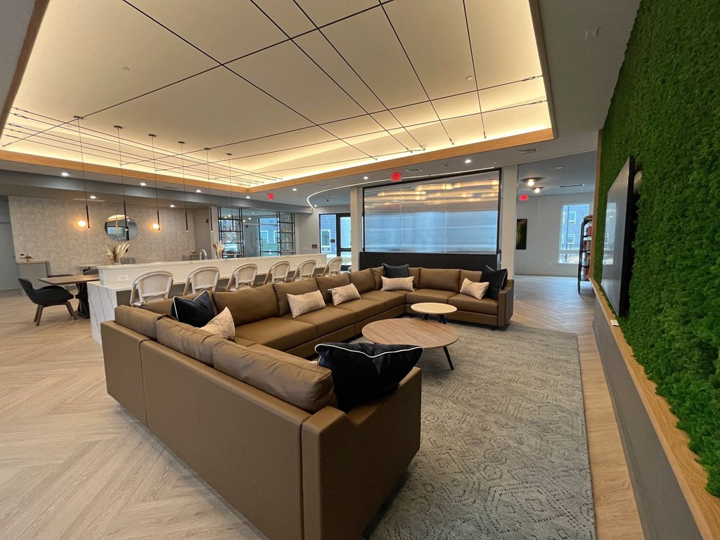 a large living room with a green wall and couches