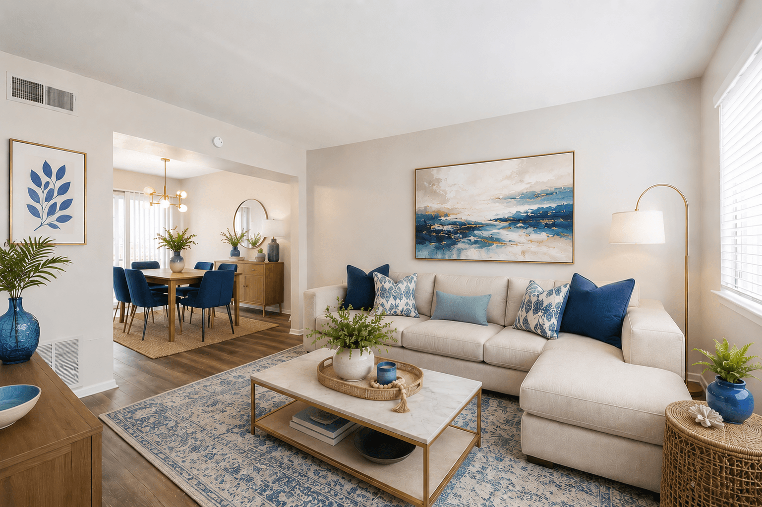 A living room with a blue vase on a coffee table.