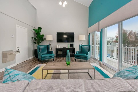 a living room with a couch and chairs and a tv