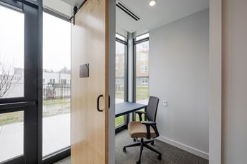 A room with a table and a chair in it.