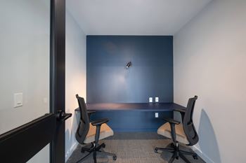 Two black chairs facing each other in a room.