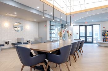A conference room with a long table and chairs.