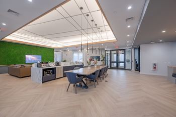 A modern office space with a long table and chairs.