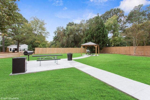 a park with a picnic table and a grill
