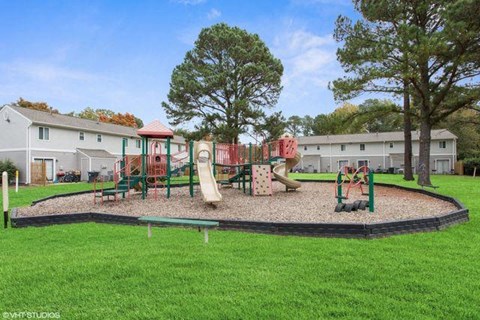 a playground is shown with a green grassy area