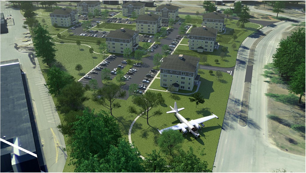 birds eye view of the community with the historic plane on the grass