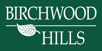 A logo with the words Birchwood Hills and a leaf symbol.