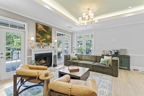 A living room with a fireplace and a painting on the wall.