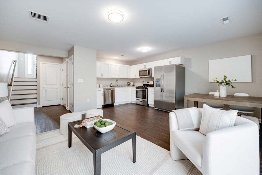 a living room and kitchen with white furniture at Pleasant View Estates, Griswold, 06351