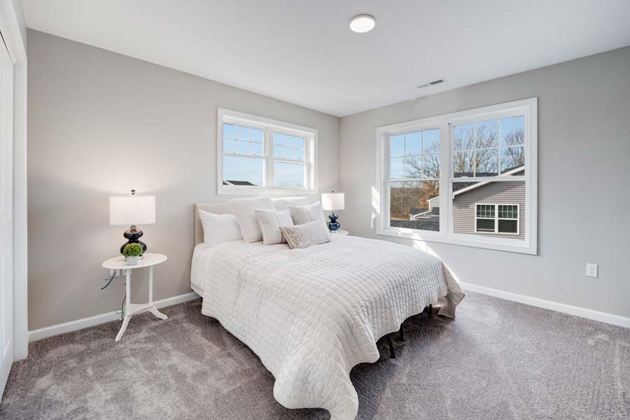 a bedroom with a bed and two windows at Pleasant View Estates, Connecticut