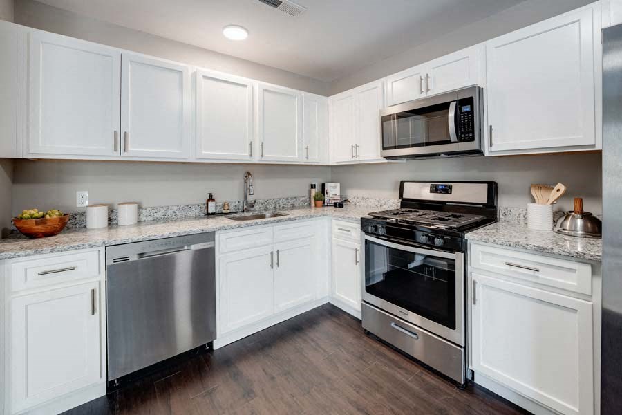 a kitchen with stainless steel appliances and white cabinets at Pleasant View Estates, Griswold, 06351