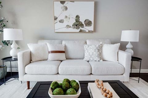 a living room with a white couch and a table