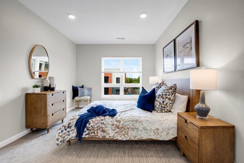 a bedroom with a bed and a window