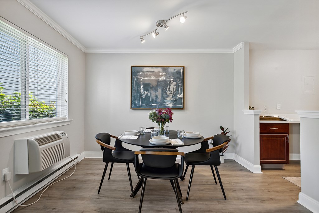 A dining room with a table set for six.