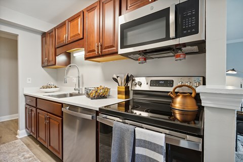 A kitchen with a stove top oven and a microwave above it.
