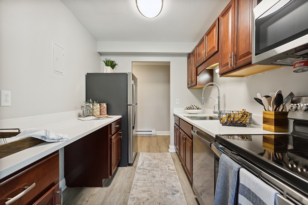 A kitchen with a refrigerator, stove, and oven.