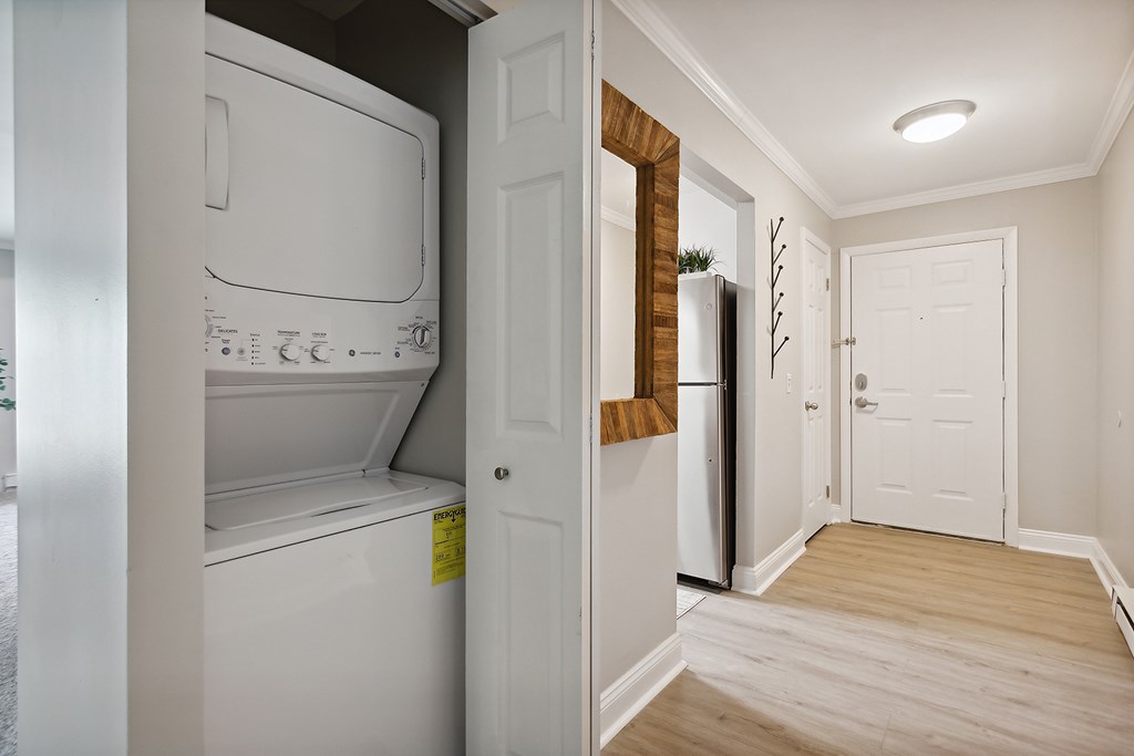 A white washing machine is in a small laundry room.