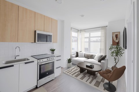 A modern kitchen with white cabinets and a black countertop.