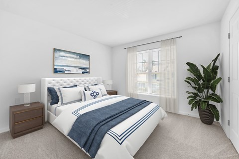 A bedroom with a large bed and a painting on the wall.