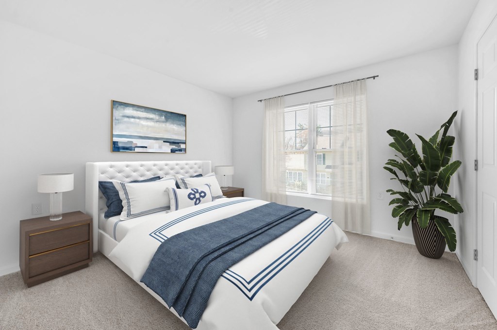 A bedroom with a large bed and a painting on the wall.