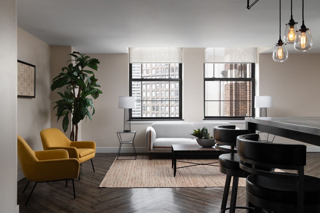 a living room with a piano and a table and chairs