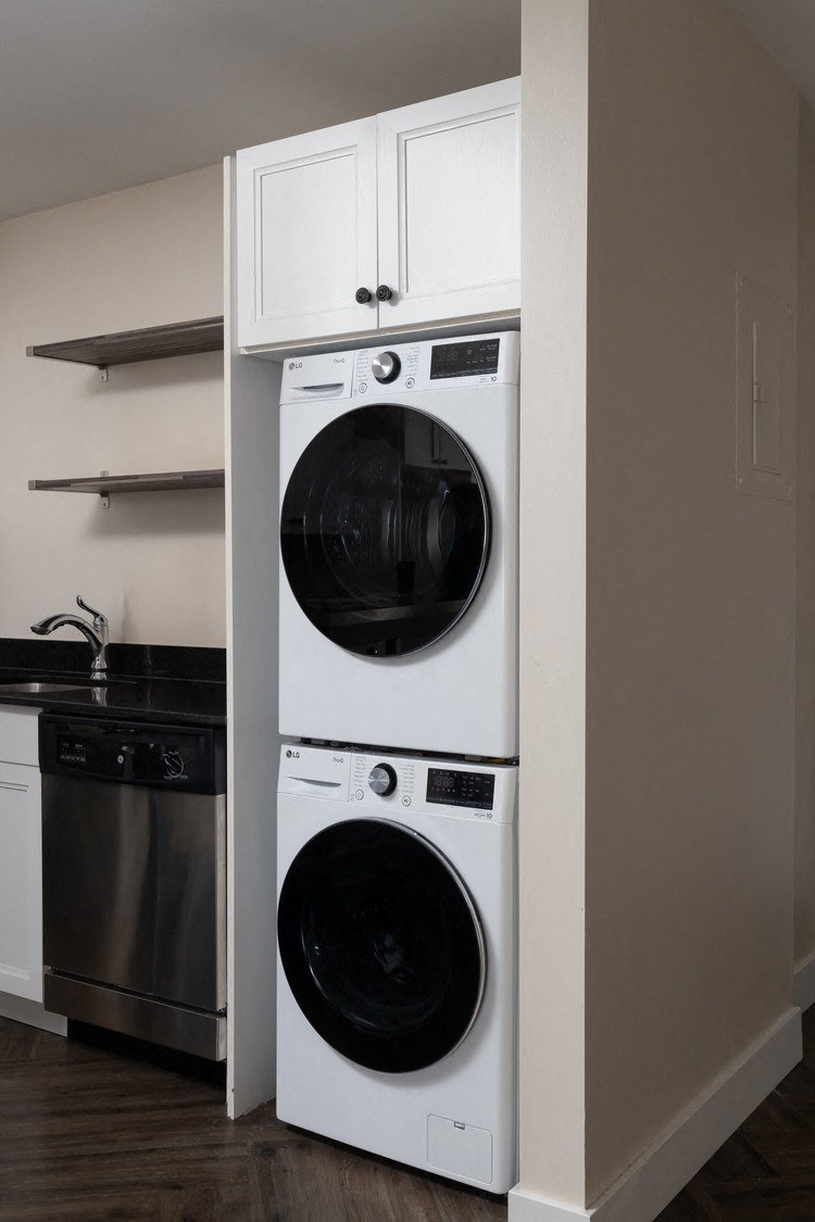 a front loading washer and dryer combo in a kitchen