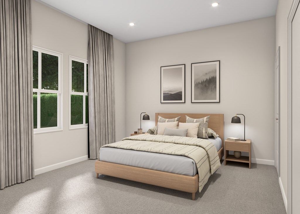 A bedroom with a large bed and two pictures on the wall.