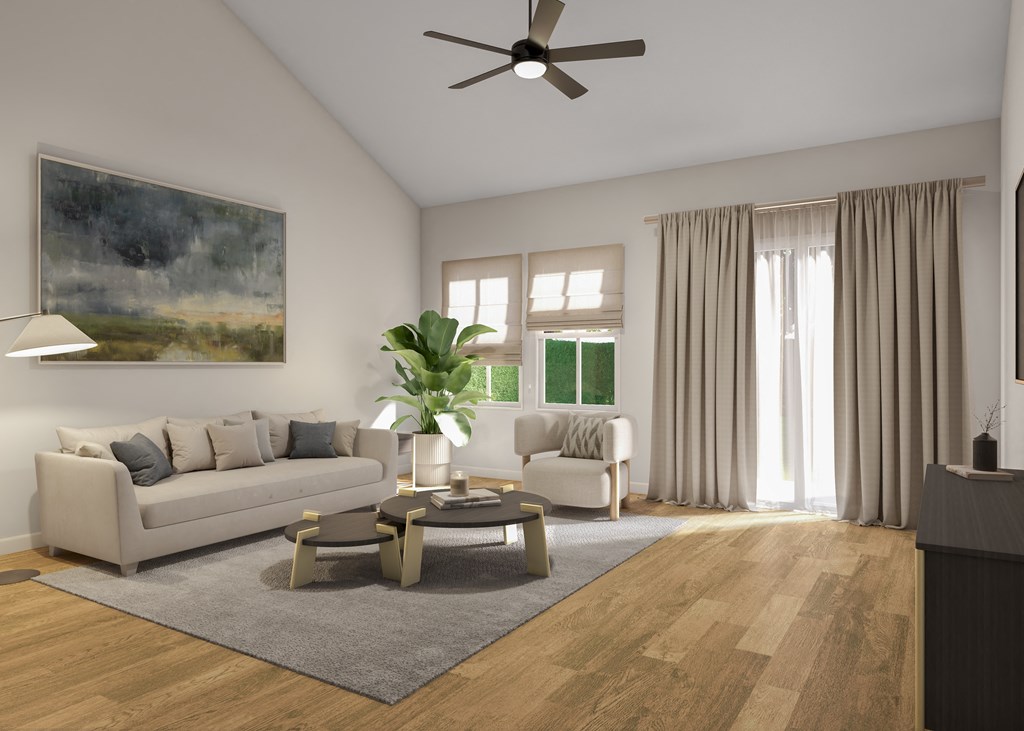 A living room with a grey sofa, a coffee table, a painting, a ceiling fan, and a window with curtains.