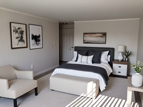 A bedroom with a large bed and a chair.