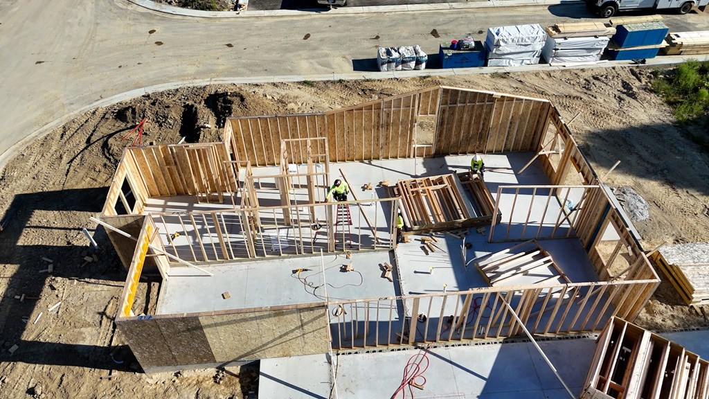 A construction site with a large wooden frame structure.