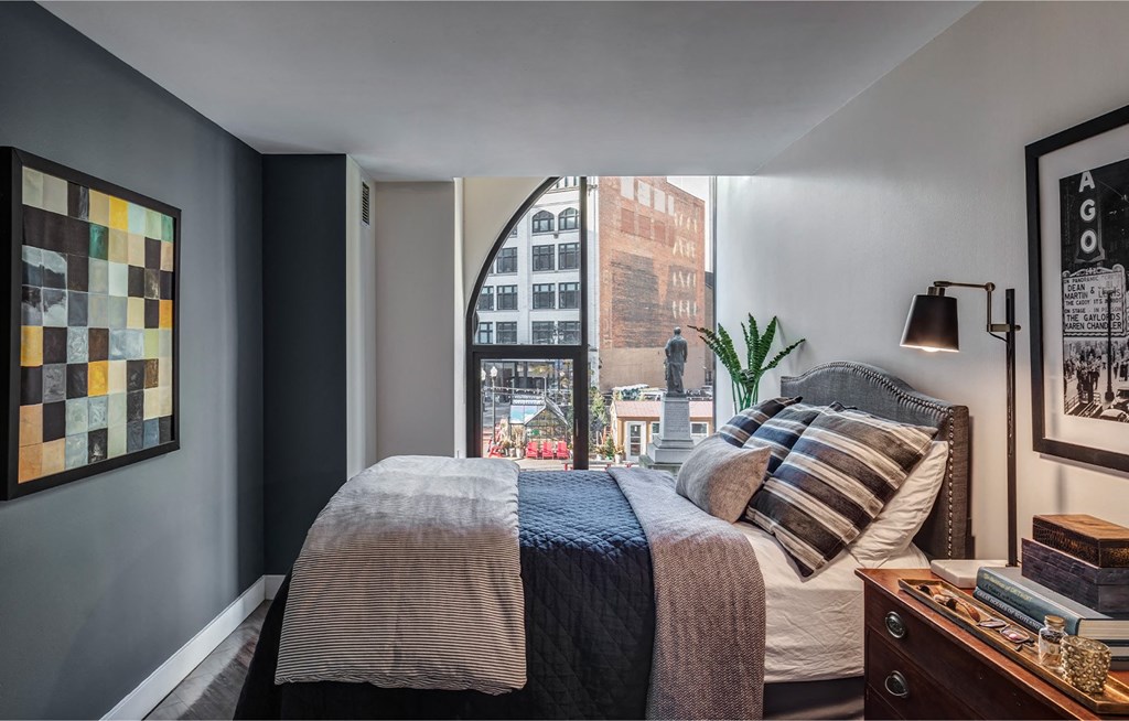 a bedroom with a large bed and a large window