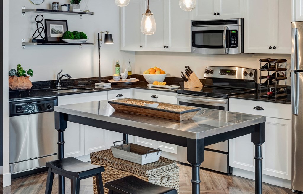 a kitchen with white cabinetry and stainless steel appliances