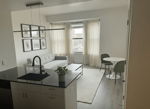 A modern kitchen with a black countertop and white appliances.