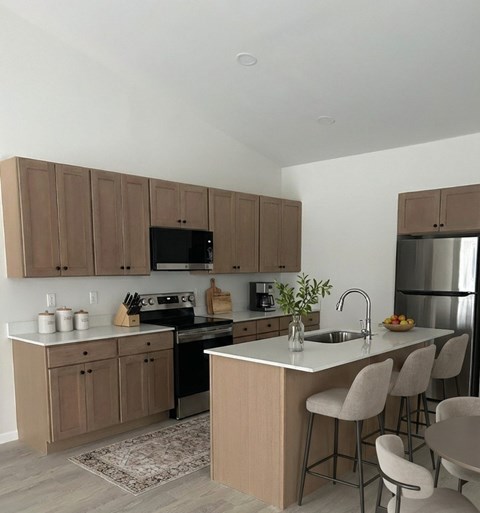 A kitchen with brown cabinets and a white countertop.