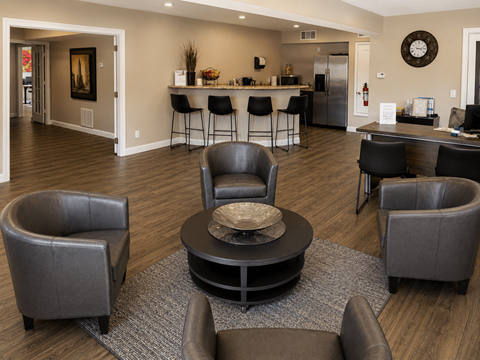 A living room with a grey sofa and a black coffee table.