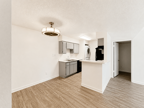 A kitchen area with a sink and a refrigerator.