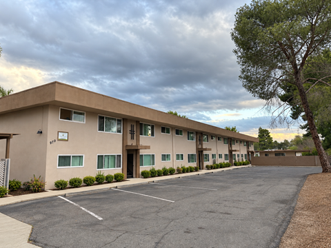 A large building with a parking lot in front of it.