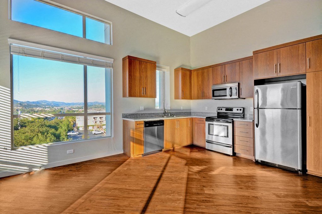 a kitchen with stainless steel appliances and a large window